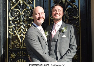 Portrait Of A Loving Gay Male Couple On Their Wedding Day.