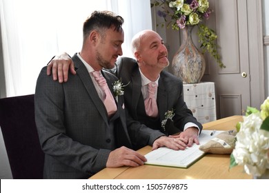 Portrait Of A Loving Gay Male Couple On Their Wedding Day.