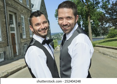 Portrait Of A Loving Gay Male Couple On Their Wedding Day.