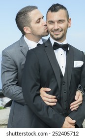 Portrait Of A Loving Gay Male Couple On Their Wedding Day.