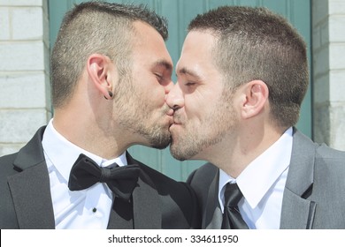 A Portrait of a loving gay male couple on their wedding day with sky on the back.