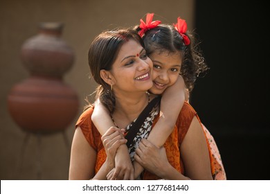 portrait of loving Indian mother and daughter at village