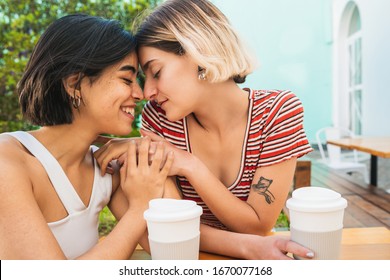 Portrait of loving lesbian couple spending good time together and having a date at coffee shop. LGBT concept. - Powered by Shutterstock