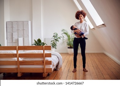 Portrait Of Loving Mother Holding Newborn Baby At Home In Loft Apartment - Shutterstock ID 1414726667
