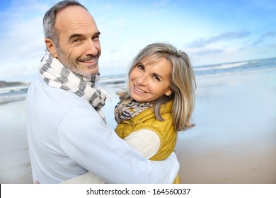 Portrait Of Loving Senior Couple At The Beach