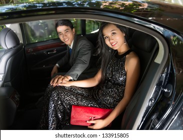 Portrait Of A Luxury Young Couple Sitting In A Car