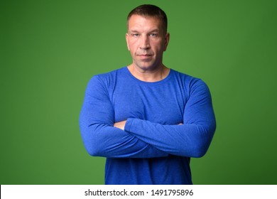 Portrait of macho mature man with arms crossed - Powered by Shutterstock