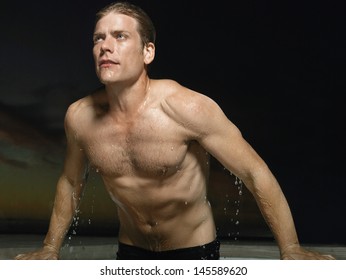 Portrait Of A Macho Young Man Emerging From Water