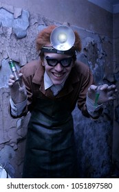 Portrait Of A Mad Scientist With A Syringe And A Bulb. Halloween Concept