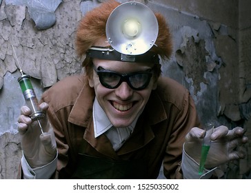 Portrait Of A Mad Scientist With A Syringe And A Bulb. Halloween Concept