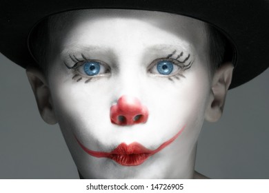 portrait of make up clown boy with red nose - Powered by Shutterstock