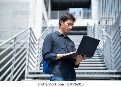 Portrait Of Male College Student Use Laptop At Campus