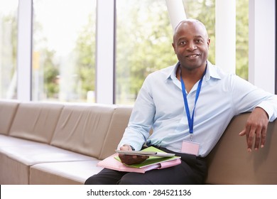 Portrait Of Male College Tutor With Digital Tablet