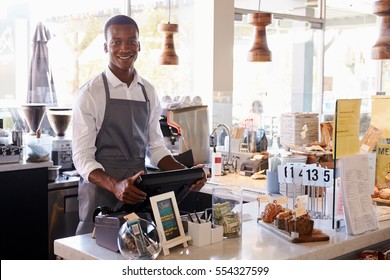 Portrait Of Male Employee Working At Delicatessen Checkout