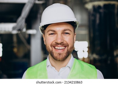 Portrait Of Male Engineer Smiling In Helmet At A Factory