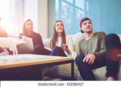  Portrait of male and female international student enjoying free time during break in university preparing for next lesson finding information in internet using laptop computer and wifi connection - Shutterstock ID 552386917