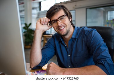 Portrait Of Male Graphic Designer At Desk In Office