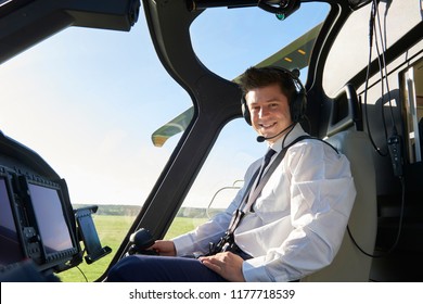 Portrait Of Male Helicopter Pilot In Cockpit Before Flight