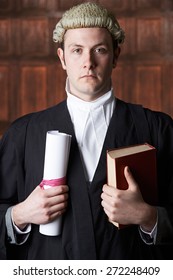 Portrait Of Male Lawyer In Court Holding Brief And Book
