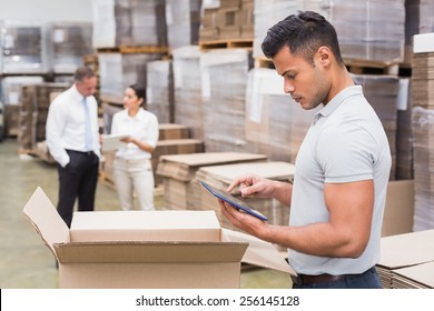Portrait of male manager using digital tablet in warehouse