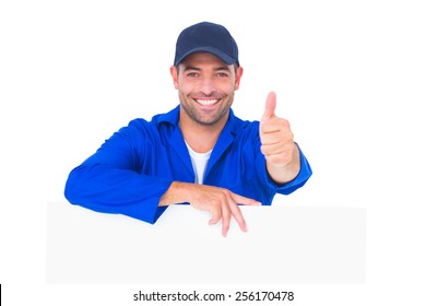 Portrait of male mechanic with blank placard gesturing thumbs up on white background - Powered by Shutterstock