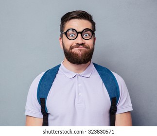Portrait of a male nerd with funny face over gray background