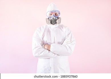 Portrait Of Male Nurse Wearing Protective Suit And Work Clothes, Putting On Protective Goggles And Mask