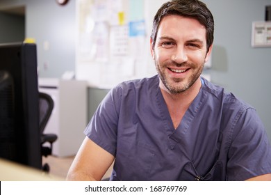 Portrait Of Male Nurse Working At Nurses Station - Powered by Shutterstock