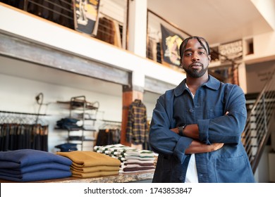 Portrait Of Male Owner Of Fashion Store Standing In Front Of Clothing Display