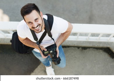 Portrait Of Male Photographer With Camera