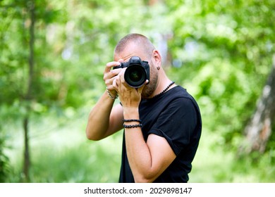 Portrait Of A Male Photographer Covering Her Face With The Camera Outdoor Take Photo, World Photographer Day, Young Man With A Camera In Hand.