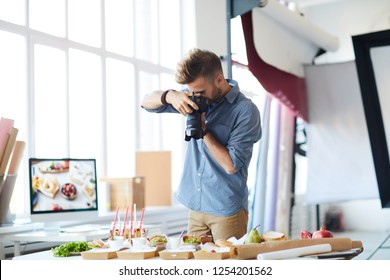 Portrait of male photographer doing food-photography while working in studio, copy space - Powered by Shutterstock