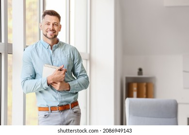 Portrait Of Male Psychologist Near Window In Office