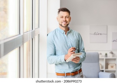 Portrait Of Male Psychologist Near Window In Office