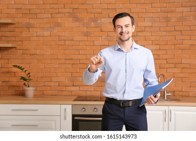 Portrait Of Male Real Estate Agent With Key Indoors