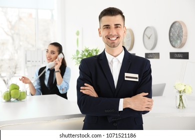 Portrait Of Male Receptionist At Workplace In Hotel