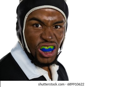 Portrait Of Male Rugby Player With Mouthguard Against White Bakground