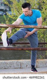 Portrait Of Male Runner Streching