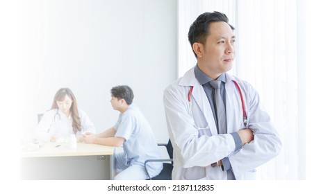 Portrait Of Male Senior Doctor Feeling Good Mood With Doctor And Patient Interaction Together On The Background