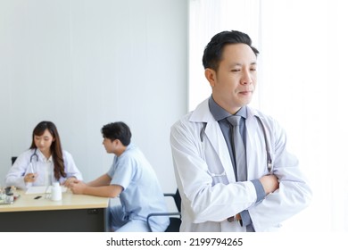 Portrait Of Male Senior Doctor Feeling Good Mood And Thinking With Doctor And Patient Interaction Together On The Background