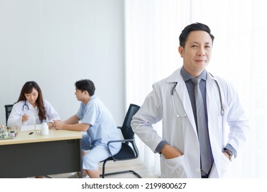 Portrait Of Male Senior Doctor Feeling Good Mood And Thinking With Doctor And Patient Interaction Together On The Background