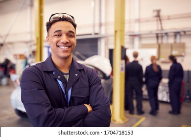 Portrait Of Male Student With Safety Glasses Studying For Auto Mechanic Apprenticeship At College