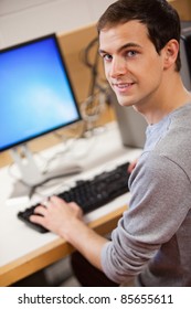 Portrait Of A Male Student Using A Computer In An IT Room