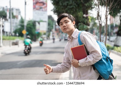 Portrait Of Male Student Waiting A Transport In A Hurry Go To Campus