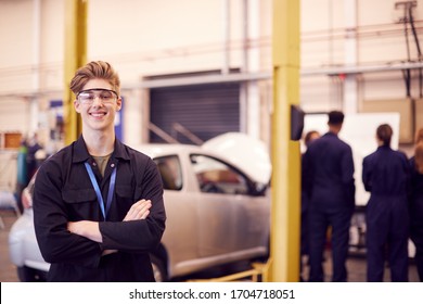 Portrait Of Male Student Wearing Safety Glasses Studying For Auto Mechanic Apprenticeship At College