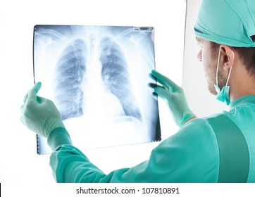 Portrait of a male surgeon examining a radiography - Powered by Shutterstock