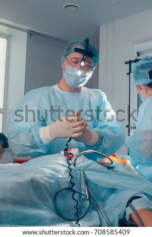 Portrait of male surgeon focused at surgery table