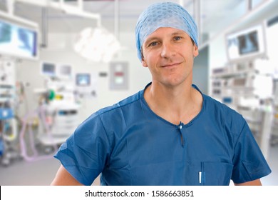 Portrait Of Male Surgeon Wearing Scrubs In Empty Operating Theater