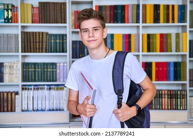 Portrait of male teenage student looking into the camera in library - Shutterstock ID 2137789241