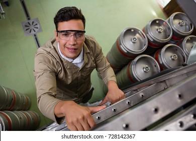 Portrait of male worker climbing ladder at warehouse - Powered by Shutterstock